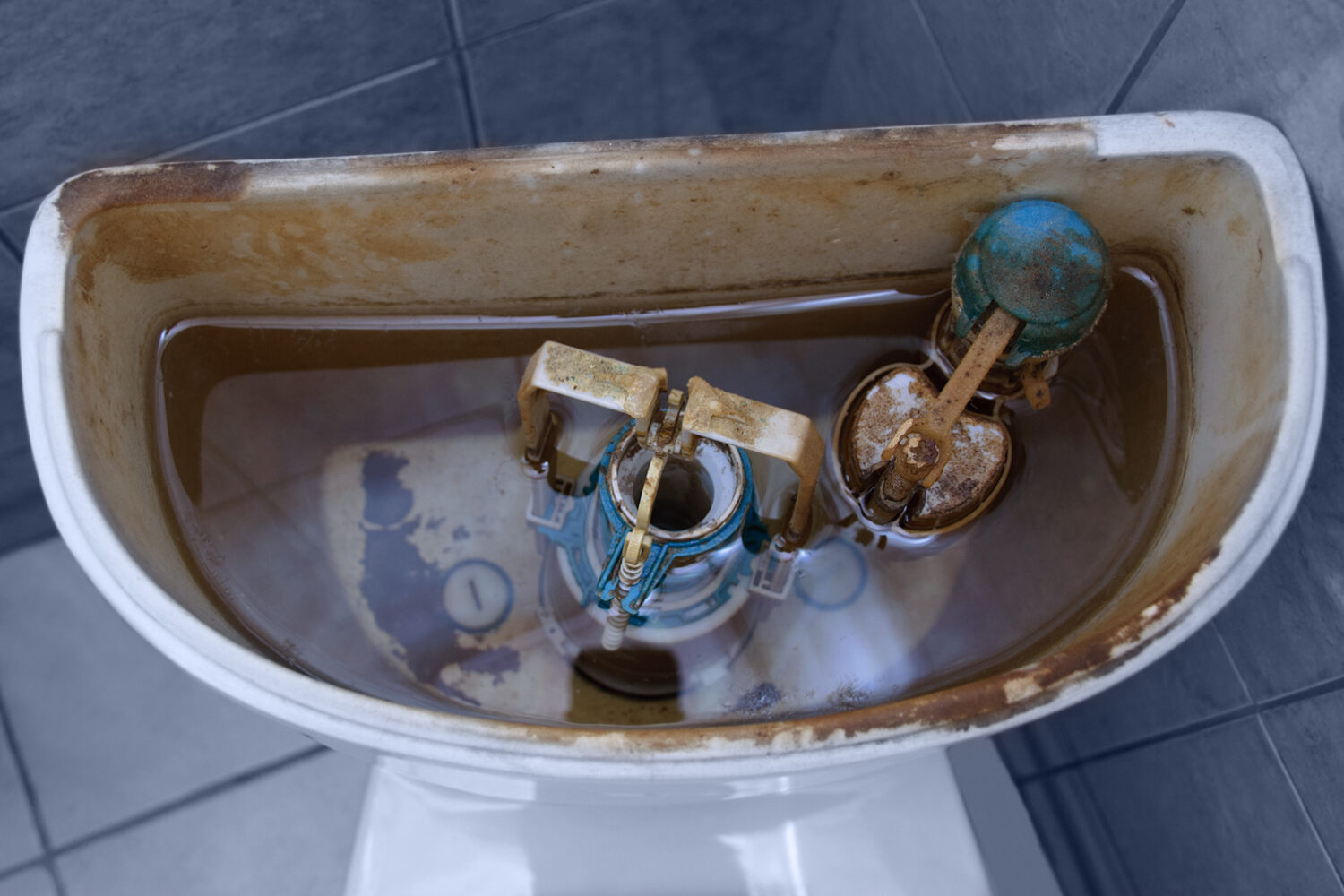 Old broken fittings in a dirty toilet and a new clean one. Plumbing repair. Before and after.